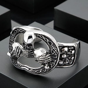 Macro shot of gothic stainless steel cuff bracelet with skull and bone carvings