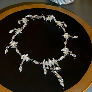 Close-up of sparkling marquise-cut crystal rhinestones on a silver statement necklace