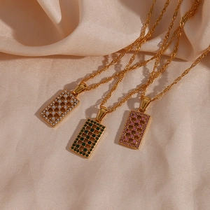 Detailed macro view of rectangular hollow maze pendants with colorful zircons on silk