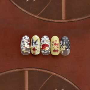 Macro shot of 3D embossed nail art stickers with rabbit, clouds, and plum blossoms