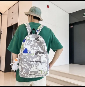 Waterproof backpack with doodle print and cute duck pendant shown on male model