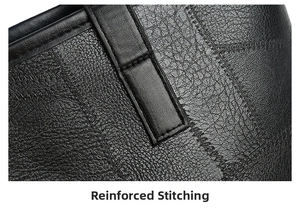 Detailed close-up of reinforced stitching and litchi texture on black leather tote bag