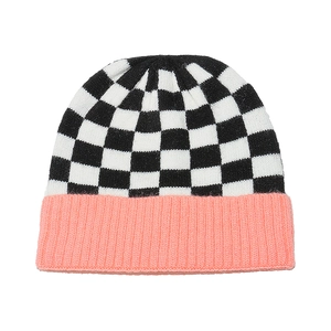 Detailed knit texture of checkerboard beanie with ribbed coral pink cuff edge