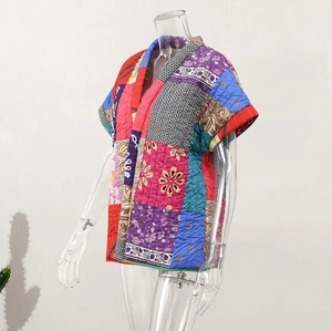 Close-up of V-neck sleeveless quilted vest with colorful patchwork and stitching