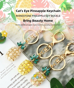 Detailed close-up of opal pineapple keychains with rhinestones and gold alloy rings