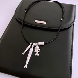Artistic silver fish and fishbone pendant necklace with adjustable black cord