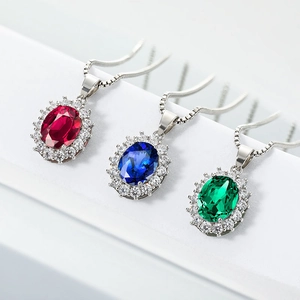 Elegant halo pendant necklace with oval red blue and green sapphires on white steps