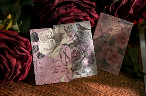 Vintage decorative cards with roses and birds on a wooden desk for scrapbooking decoration