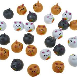 Detailed view of colorful bunny figurines with carrots in white brown and grey tones