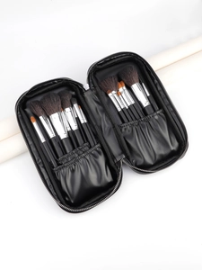 Detail of a black PU makeup brush case showing organized brushes and elastic slots