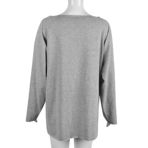Detail view of the back of a grey long-sleeved cutout sweatshirt on a mannequin