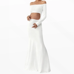 Detail of white off-shoulder maternity dress with waist cutout and long sleeves