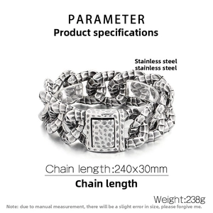 Detail of vintage steel Cuban chain bracelet with textured dragon scale surface on stand