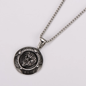 Detailed close-up of a silver stainless steel lion head relief pendant with Greek key border