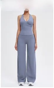 Close-up of high-waist wide-leg yoga pants and V-neck crisscross sports top in smoky blue