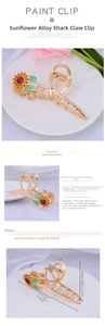 Macro view of sunflower alloy hair claw clip with golden finish and crystal details
