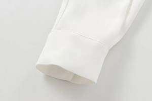 Close-up of elegant white crepe shirt cuff showing fine stitching and fabric texture