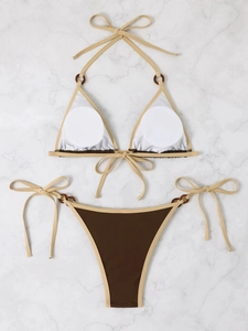 Detail view of contrast color bikini set with halter neck ties and decorative rings