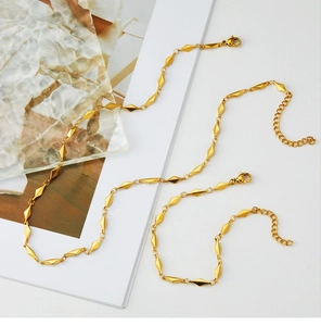 Detail of 18K gold plated stainless steel necklace with geometric rhombus beads and clasp