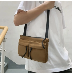 Brown nylon crossbody bag with multi-pocket design shown on model for casual wear