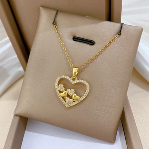 Detail of a hollow heart pendant in gold finish with sparkling cubic zirconia inlay