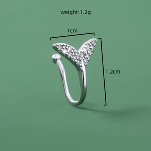 Macro shot of silver fishtail ear clip with small crystals and size specs 1cm by 1.2cm
