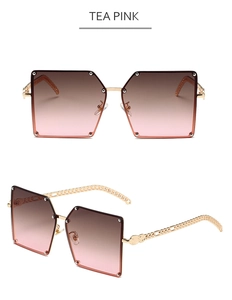 Detail of square tea pink sunglasses with gold chain temples and rivet accents