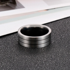 Detail of matte titanium steel ring featuring double beveled edges and brushed finish texture