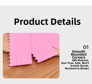 Detail view of pink ABS plastic cake scraper with smooth rounded corners and serrated edges