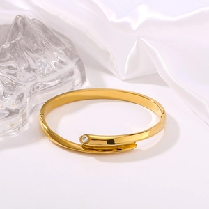 Minimalist 18K gold plated stainless steel open bangle with a single zircon accent