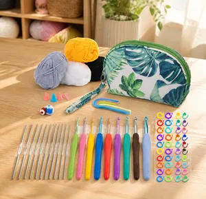 Detailed crochet set with colorful ergonomic needles, yarn, and tropical leaf storage pouch