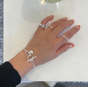 Detail showing 925 silver star ring, heart charm bracelet and minimalist bands set