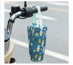 Detail of dark blue fabric cup holder with cartoon rabbit patterns and portable handle