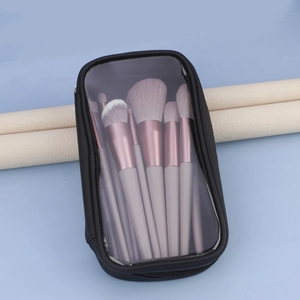 Makeup brush set with rose gold ferrules and clear storage bag on display stands