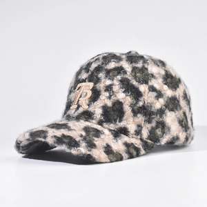 Detail of plush leopard print baseball cap with embroidered letter R and soft texture