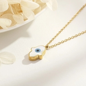Detailed side view of 18k gold plated Hamsa hand necklace with blue evil eye charm