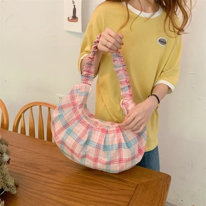Detail of blue and pink checkered canvas hobo bag with a scrunchie pleated handle