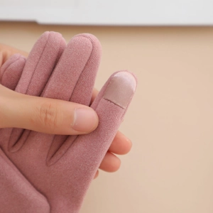 Close-up of pink wool gloves with specialized touchscreen sensitive fingertips