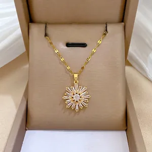 Elegant gold snowflake pendant necklace with cubic zirconia stones in a luxury jewelry box