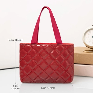 Detail view of a red quilted tote bag with specific dimensions in inches and centimeters
