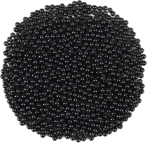 Close-up of smooth round black beads with center holes for DIY jewelry making craft