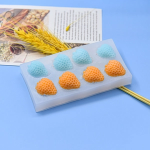 8-cavity strawberry silicone mold for DIY baking and handmade soap on blue background