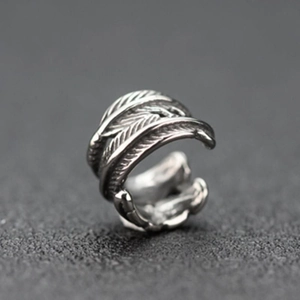 Macro shot of silver feather ear clip showing vintage texture and adjustable design