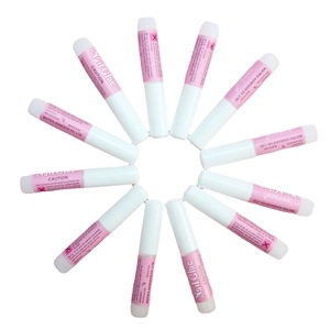 Radial arrangement of 12 tubes of professional nail glue for press-on nails on white background