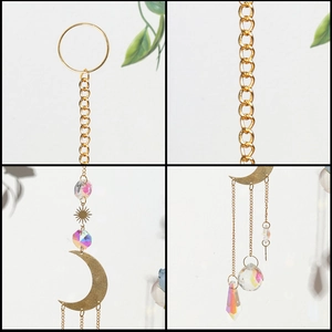 Macro detail of gold moon and star metal frame with iridescent crystal prism suncatcher