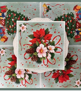 Macro detail of Christmas napkin with poinsettia and pinecones on a white porcelain plate
