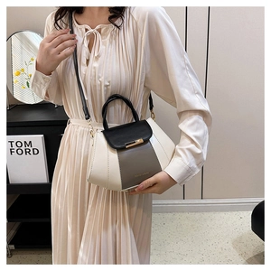 Detail of tricolor PU leather handbag with gold hardware and FASHION & BAGS logo