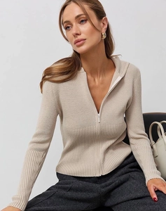Detail of beige ribbed knit texture and metallic half-zip closure on the slim sweater