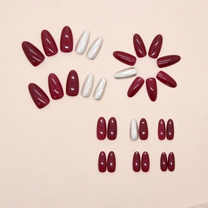 Detail of burgundy and 3D textured silver press-on nails in various sizes