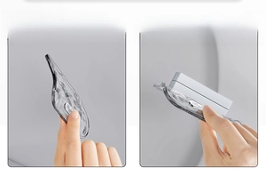 Detail showing transparent grey toilet lid lifter with thick and thin sponge pads